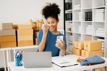 Small business entrepreneur SME freelance African woman working at home office, BOX,tablet and laptop online, marketing, packaging, delivery,  e-commerce concept