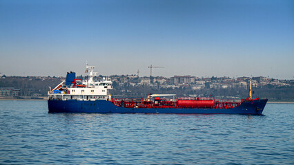 Big gas tanker or cargo ship in the sea harbour on sunny day