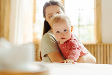 Young smiling babysitter spending time with cute little baby