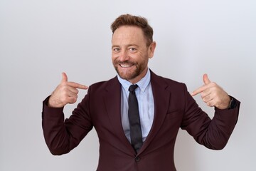 Middle age business man with beard wearing suit and tie looking confident with smile on face, pointing oneself with fingers proud and happy.