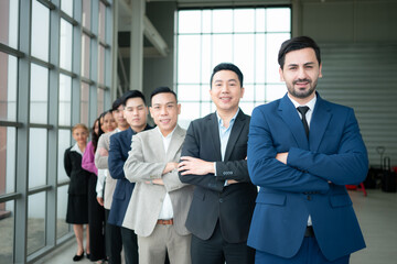 Group of business people standing in line in conference room used for meeting in modern office