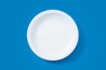 Disposable waste plastic on blue background. Top view