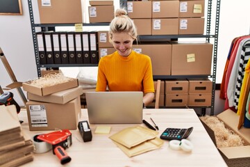 Young blonde woman ecommerce business worker using laptop working at office