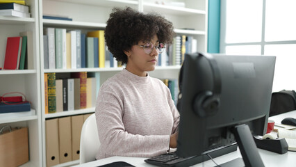 Young african american woman student using computer studying at university classroom