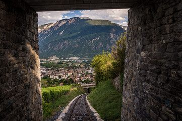 Fototapeta na wymiar Tunnels and railways. Light on the end of the tunnel. Crans Montana, Valais Canton, Switzerland.