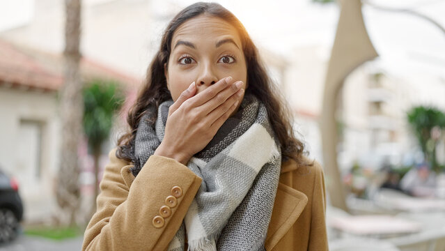 Young beautiful hispanic woman standing with surprise expression at street