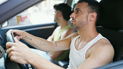 Two men couple driving car at street