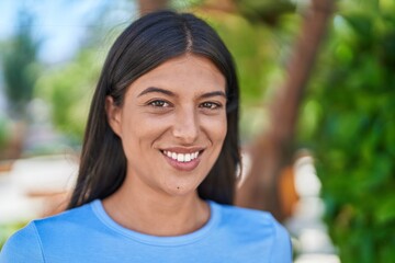 Young beautiful hispanic woman smiling confident standing at park