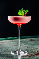 alcohol cocktail in a glass stands on a table in a bar or restaurant