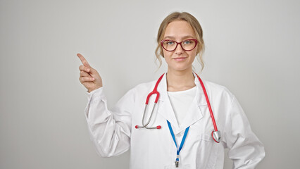 Young blonde woman doctor smiling pointing to the side over isolated white background