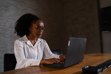 Black businesswoman working on laptop. Portrait of beautiful businesswoman in the office.