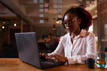 Black businesswoman working on laptop. Portrait of beautiful businesswoman in the office.