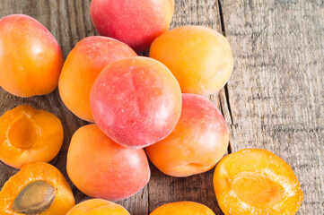 Top view of bowl of fresh ripe apricot on a wooden table
