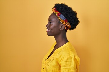 African young woman wearing african turban looking to side, relax profile pose with natural face...