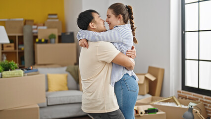 Man and woman couple smiling confident hugging each other at new home