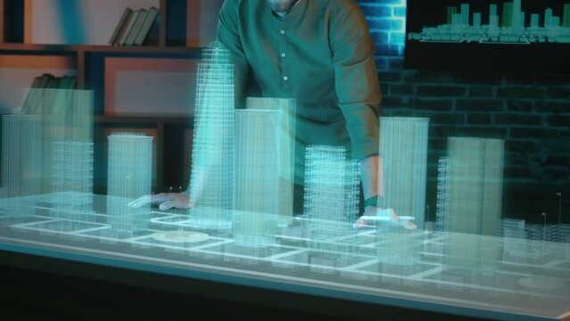 Professional architect working on a project and looking at digital blueprints.