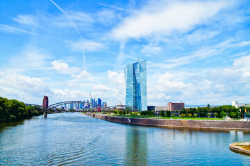 Fototapeta premium view of the river Main and ECB with the european city skyline ,financial centre of Frankfurt. Skyscraper buildings in Germany on blue sky background. Business and finance concept