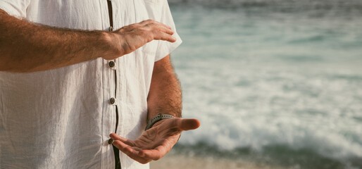 man doing qigong on tropical beach