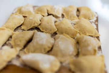 Raw dumpling. Preparation dumplings on a wooden board.