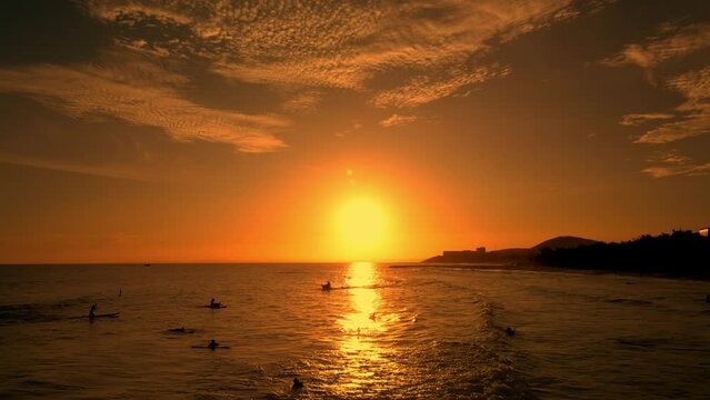 Happy with riding on sea wave on surfboard, people on vacation swimming in the sea,. Surf sea background at sunset. Surfers rides big wave against backdrop beautiful sunset on the sea Vietnam. 4K