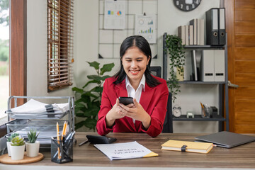 Beautiful business asian woman with working office desk using phone and computer laptop