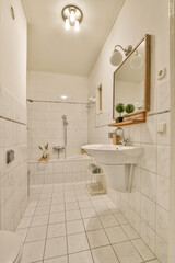 Fototapeta na wymiar a bathroom with white tile and wood trim around the tub, toilet, sink, and mirror on the wall
