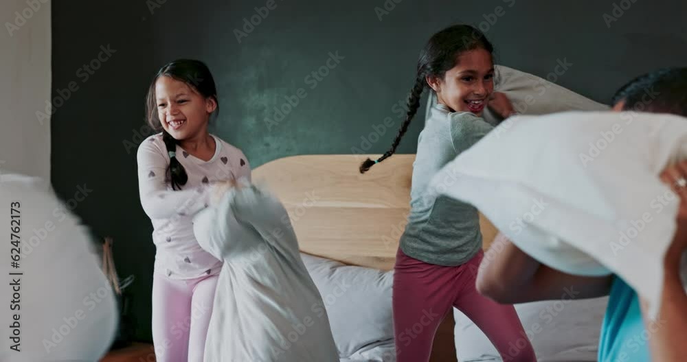 Wall mural Happy, bedroom and children in a pillow fight with their parents for fun, playful or bonding together. Happiness, smile and girl kids playing with their mother and father on bed in their family home.