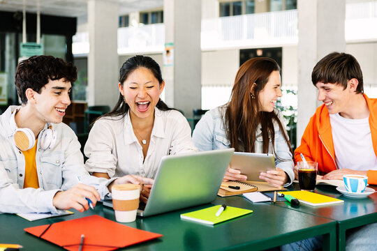 Diverse Group Of Happy High School Students Studying Together On Campus. Technology And Education Lifestyle Concept.