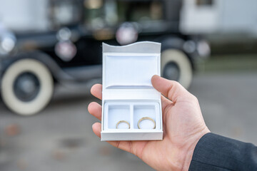 Groom hold in hand Romantic marriage couple wedding Symbols rings in a white box