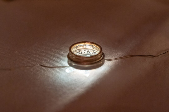 Two wedding rings illuminated backlight with beautiful bokeh, close-up photo