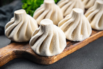 khinkali with meat frozen product semi finished Georgian cuisine vegetables food healthy meal food snack on the table copy space food background rustic top view