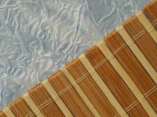 bamboo texture, material with a visible pattern, dark yellow and light planks tied with a string, bamboo mat, in the light and shadow. background, wallpaper for various graphics