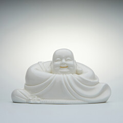laughing Buddha in the form of a white porcelain figurine