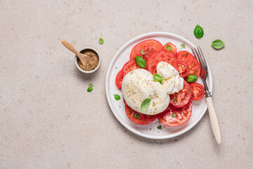 Gourmet tomato salad with burrata cheese, olive oil and spices. Italian food concept. Food background top view with copy space