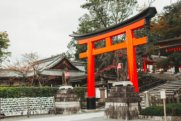 Torii red wooden gate Japan traditional in Shinto shrines temple entrance symbol of transition from the mundane to the sacred