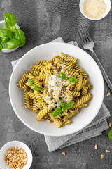 Fussili pasta with basil pesto sauce, parmesan cheese and pine nuts. Traditional Italian food.