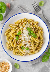 Fussili pasta with basil pesto sauce, parmesan cheese and pine nuts. Traditional Italian food.
