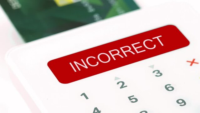 Closeup finger entering incorrect or wrong pin (personal identification number) for electronic purchasing by credit or debit card