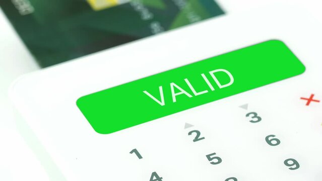 Closeup finger entering valid pin (personal identification number) for electronic purchasing by credit or debit card