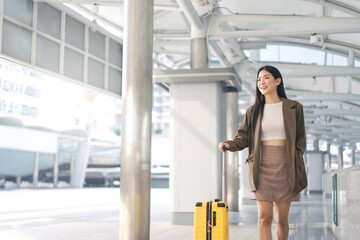 Freelance young asian woman walking with travel luggage for business trip