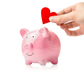 piggy bank and a hand with a red heart, on a white isolated background, support and donations
