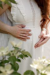 pregnant woman white dress outside belly hands