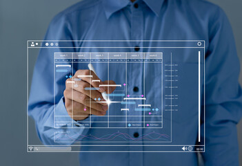 Project manager working with Gantt chart schedule to plan tasks and deliverables. Corporate...