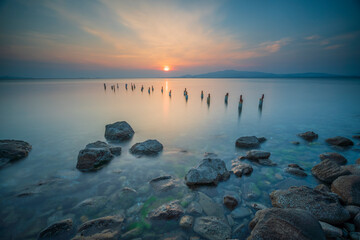 seaside and rocks taken at sunset with pier ruins and long exposure photos