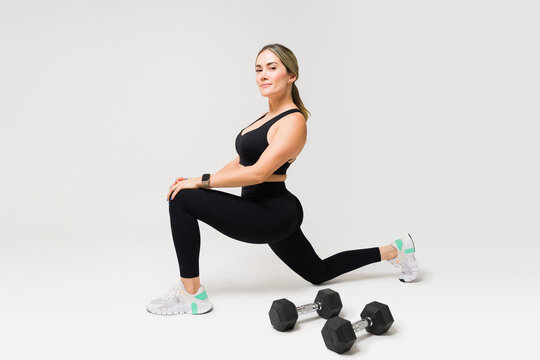 Caucasian Active Woman At The Gym Using Dumbbell Weights