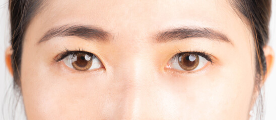 Close up of beauty asian woman eyes on white background. Eyes health care concept.