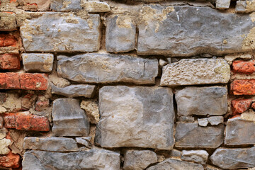 Stone wall texture, Background for design. Old and grungy surface. Solid construction material. Masonry craft and skill.