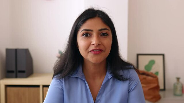 POV screen view of young indian businesswoman talking with colleague on laptop video call. Head shot of confident professional ethnic female having an online conversation. 