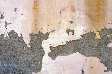 Old rough concrete wall covered with peeled dirty white paint. Abstract textured background.