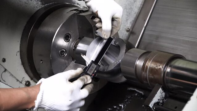 Quality control manufacturing.Hands of an engineer measures a metal part with a digital vernier caliper